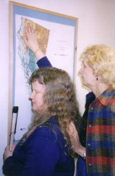 Nancy Burns points out to Jana Littrell the relief map of California which hangs on the office wall
